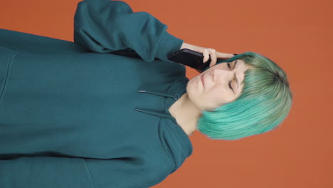 Vertical-video-of-Young-woman-getting-bad-news-on-the-phone-gets-upset.