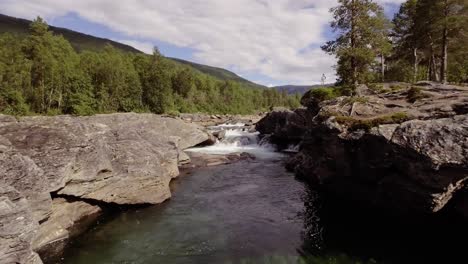 aerial of a small river with rapids and pools in northern norway