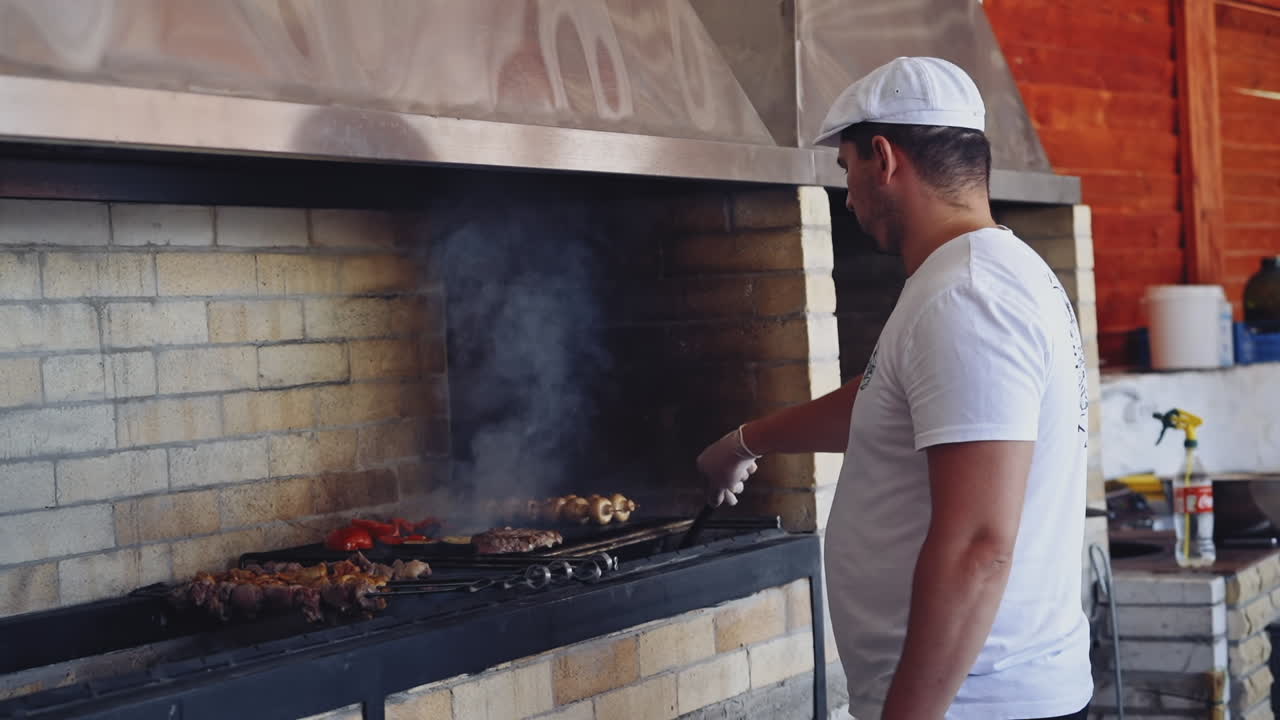 Chef preparing food. Portrait of serious man working at restaurant