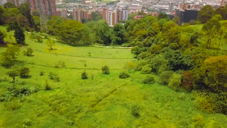 Beautiful-revealing-aerial-shot-of-city-of-Medellin-green-hills-4k-drone