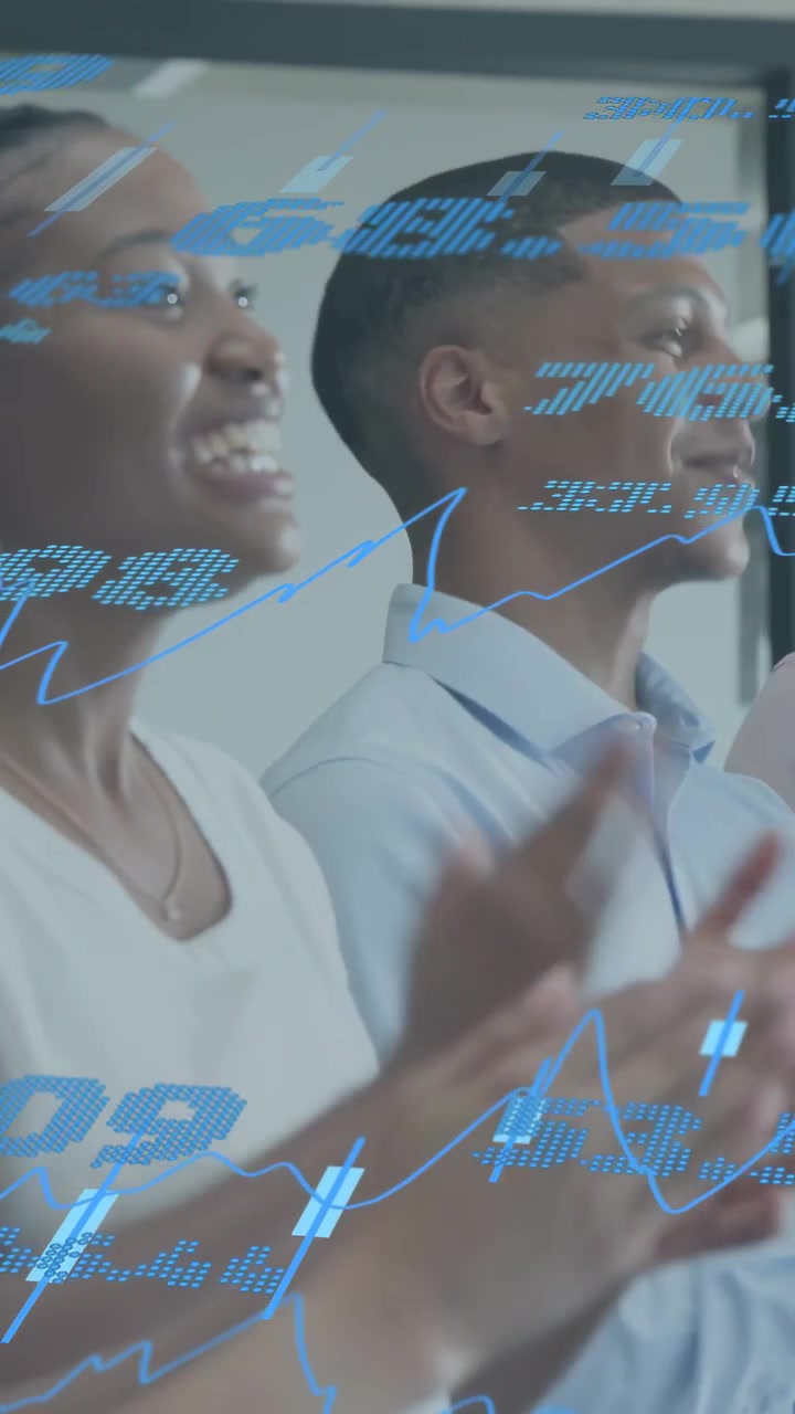 Vertical video: Business team clapping reacting to off-screen news, blue data overlay over hands