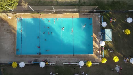 Overhead-Shot-Of-Public-Blue-Swimming-Pool-At-Club-Of-Buenos-Aires-City-at-sunset