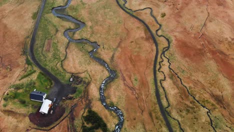 Aerial-footage-of-a-river-coming-from-the-Bjarnarfoss-waterfall-located-in-Iceland