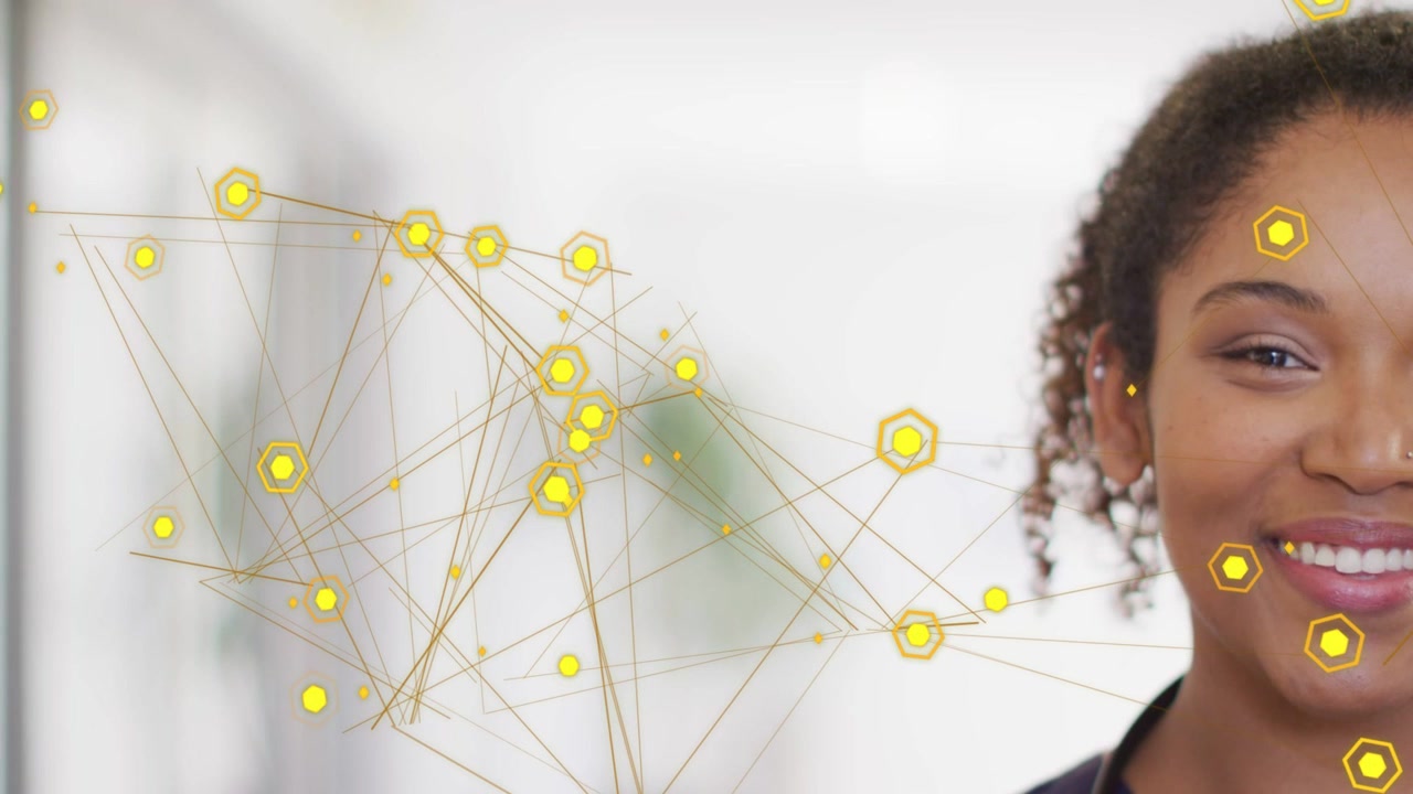 Woman clinician standing with stethoscope right, yellow nodes moving placing hexes on face smiling