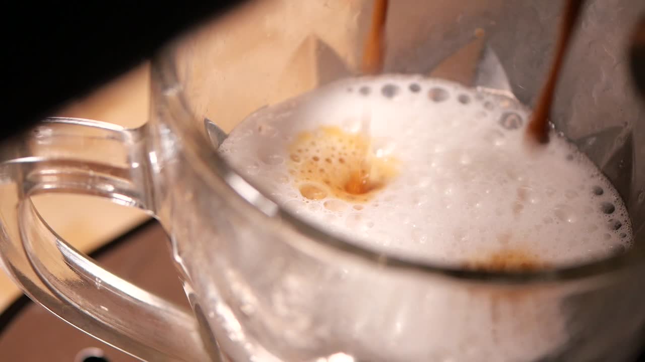 Espresso being poured into a cappuccino