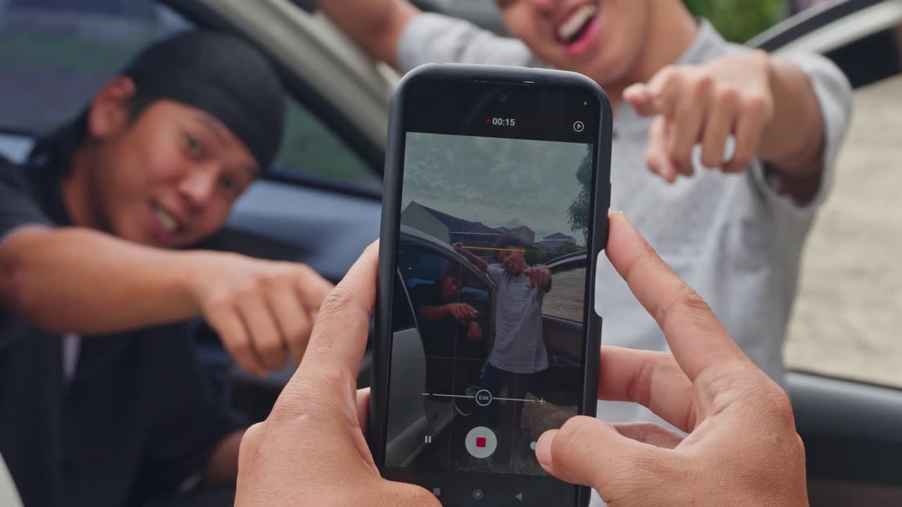 POV of recording vlog with friends near vehicle during eid homecoming