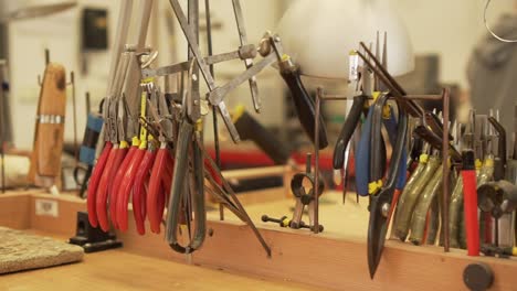 Detail-of-workroom-full-of-pliers,-tweezers,-splitters,-files-and-other-tools-in-slow-motion