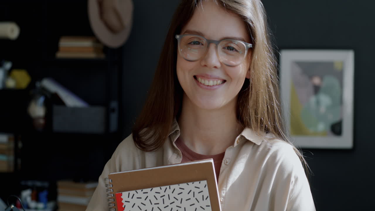 Smiling Student with Notebooks