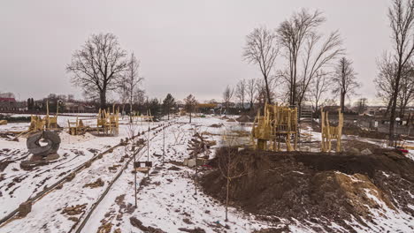 Hig-angle-shot-of-construction-workers-busy-in-construction-of-a-kids-on-playground-in-timelapse-on-a-cloudy-day