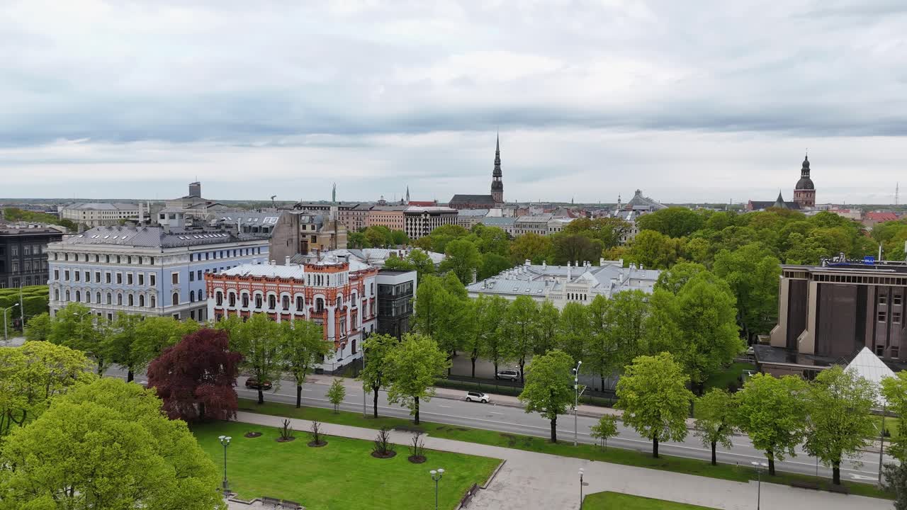 Freedom Monument in Riga rises proudly with a grand church and cityscape in the background.
