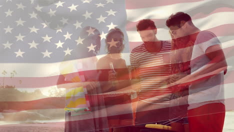 group of friends at the beach and the american flag for fourth of july.