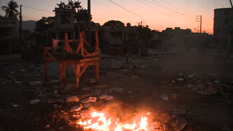 an open fire burns on the streets of haiti following an earthquake 2