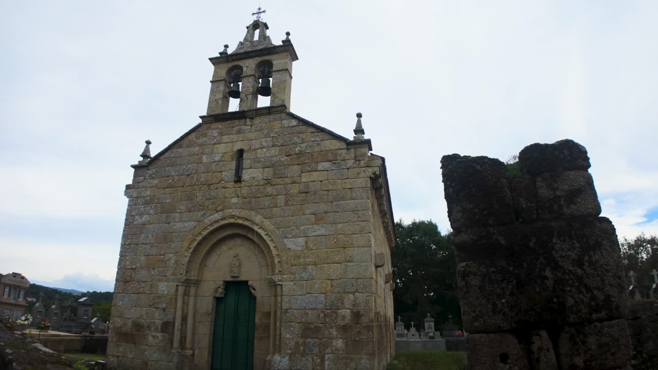 Old church of San Paio de Albán with arched green door, located in Coles, Galicia, Spain