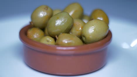 close-up of a bowl of marinated green olives