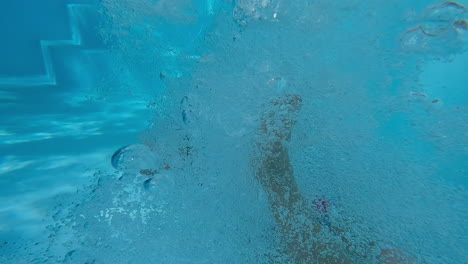 girl swimming to mom underwater