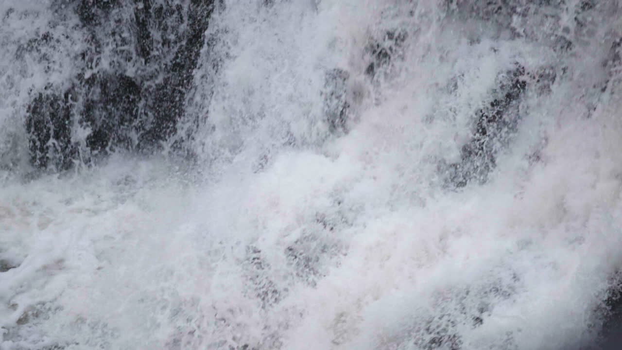Slowmotion of water splashing in the waterfall