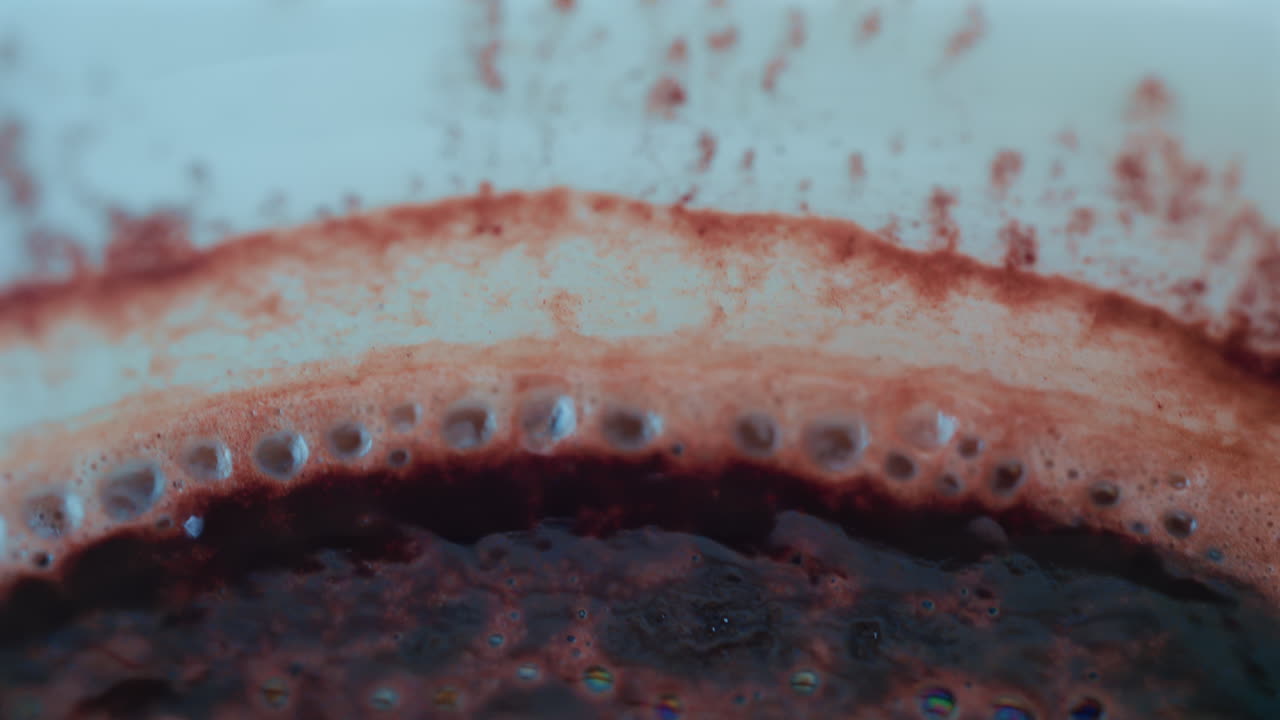 Close up of a rich hot chocolate or coffee surface sprinkled with cocoa powder