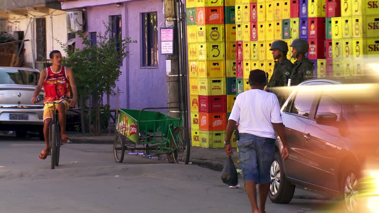 Police patrol the crowded streets of the favela in Rio de Janeiro, Brazil
