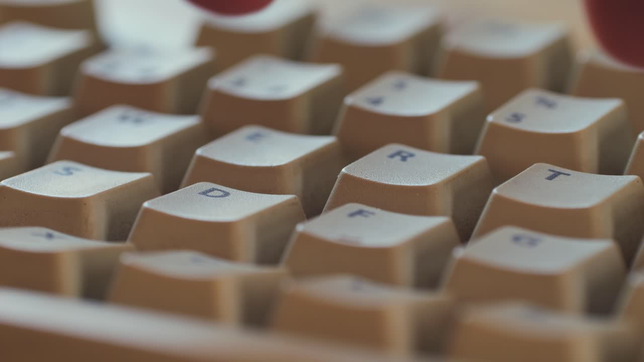 Man working and gaming on retro computer PC, IT engineer with vintage computer at home, using old fashion technology, close up of retro setup.