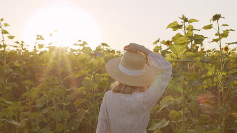 girl in sunglasses posing for camera in field