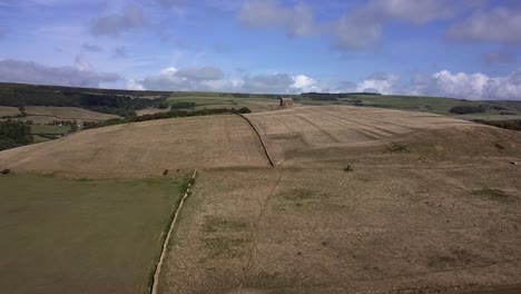 aerial tracking forward towards st catherine's chapel, near weymouth, and the village of abbotsbury lies behind the hill