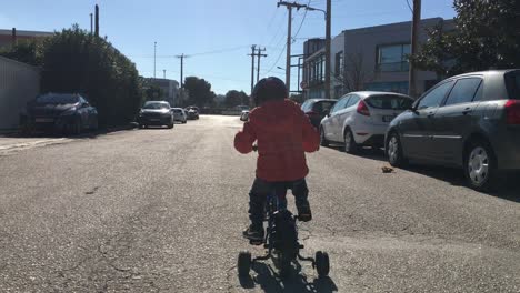 Follow-shot-of-kid-riding-a-bike