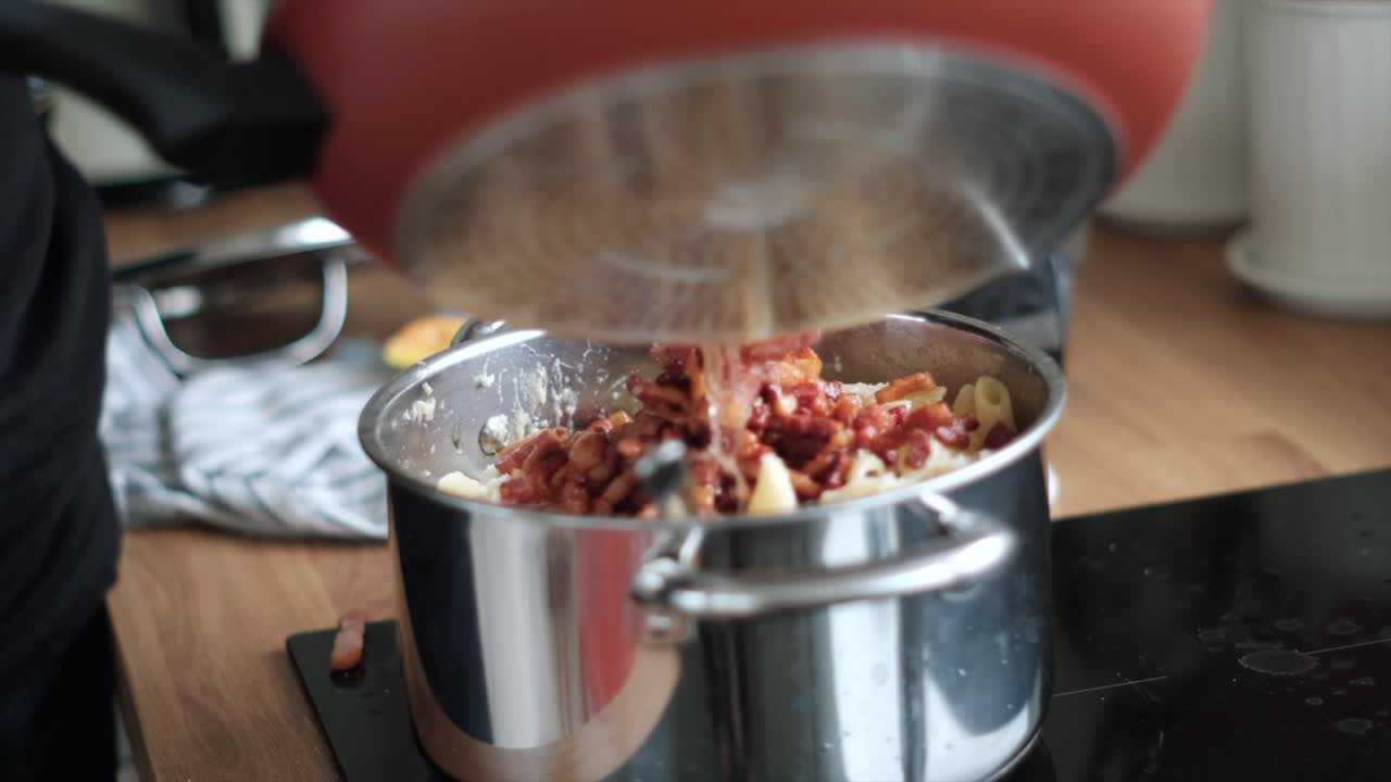Slow Motion Flavor: Man Pouring Pancetta, Guanciale, or Bacon into Pasta for Carbonara