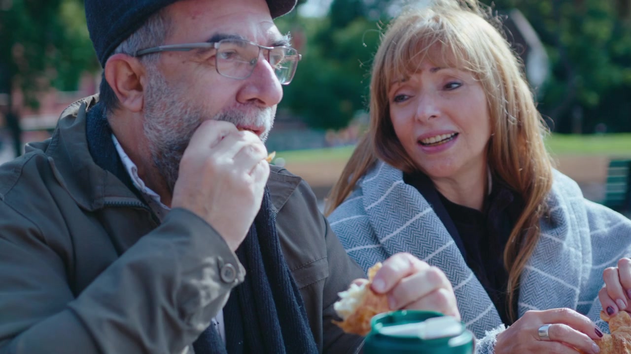 Senior Man and Woman Enjoying Meal in the Park
