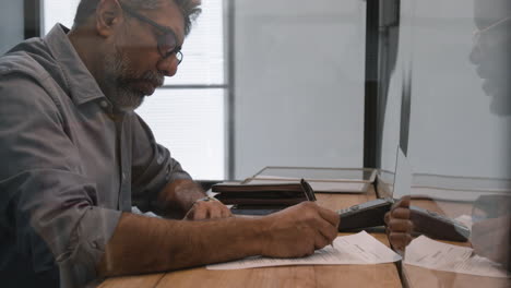 businessman signing document in office