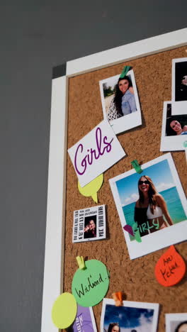polaroid photos of friends on a corkboard