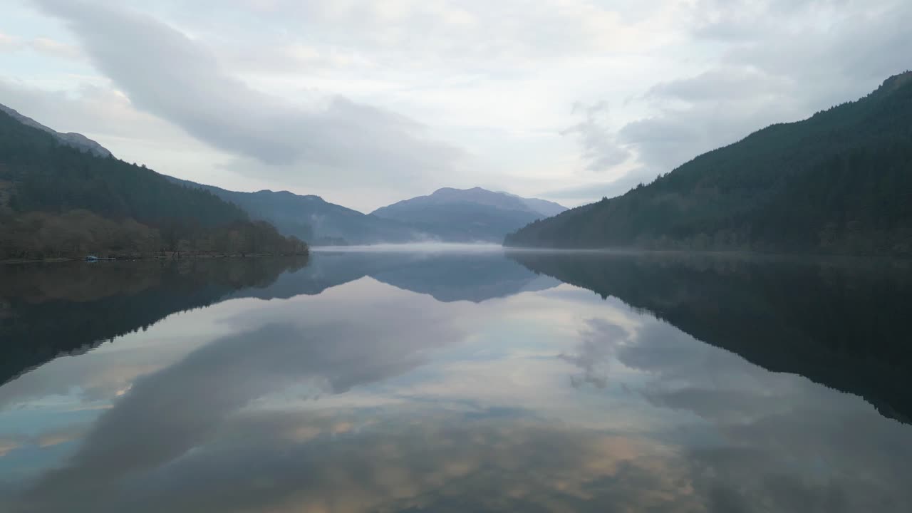 Peaceful Aerial of Scottish Loch with Dramatic Cloud Reflections