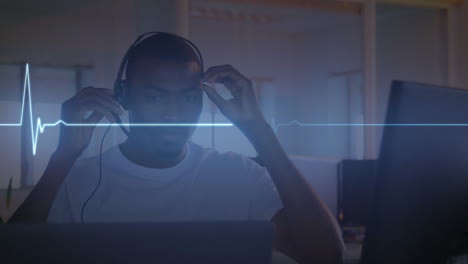 Animation-of-illuminated-heart-rhythm-over-african-american-man-listening-through-headphone