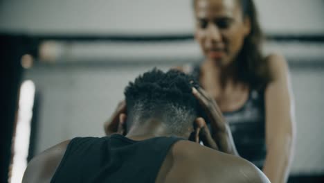 man doing sit ups with personal trainer