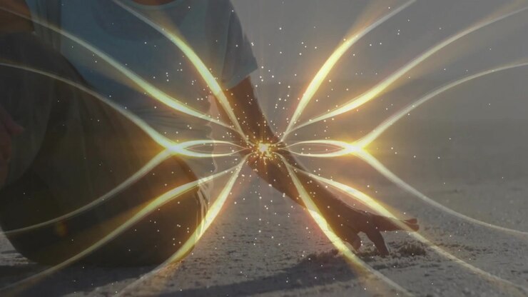 Senior woman sensing pulsing golden energy, leaning over shore and sifting sand demonstrating tech