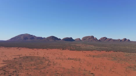 kata tjuta - mount olga with red sand desert landscape in foreground - domed rock formations or bornhardts in northern territory, australia