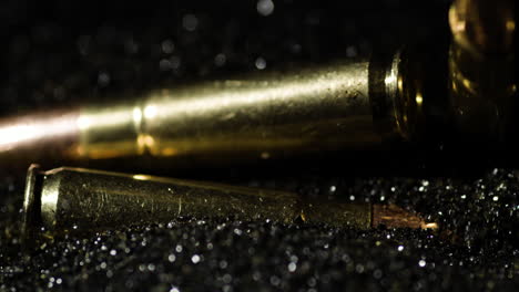 close-up of ammunition cartridges on a dark, sparkling background