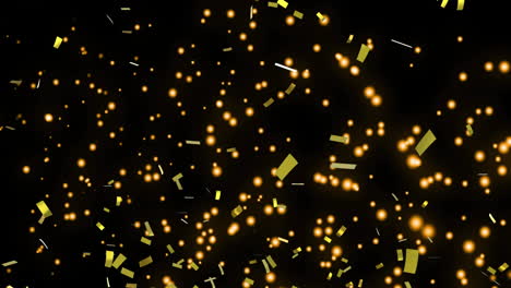 confeti dorado y manchas brillantes moviéndose contra un fondo negro