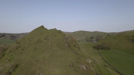 4k drone footage of a big, green, beautiful hill in the peak district