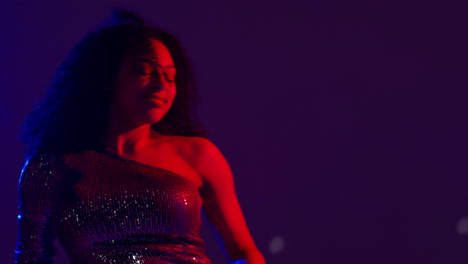 Close-Up-Of-Young-Woman-In-Nightclub-Bar-Or-Disco-Dancing-With-Sparkling-Lights-10