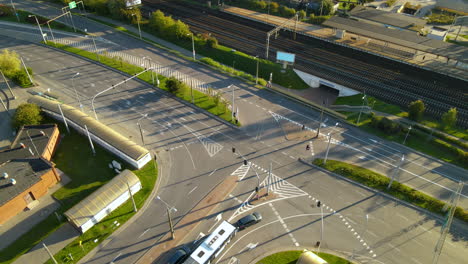 articulated bus with cars stopped at an intersection and wait for the light signal to turn green at the city of gdynia, poland