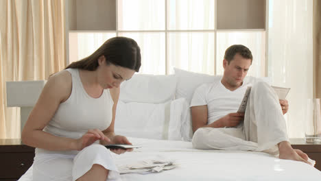 woman checking bills in the bedroom