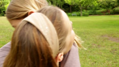 happy mother and daughter playing in the park