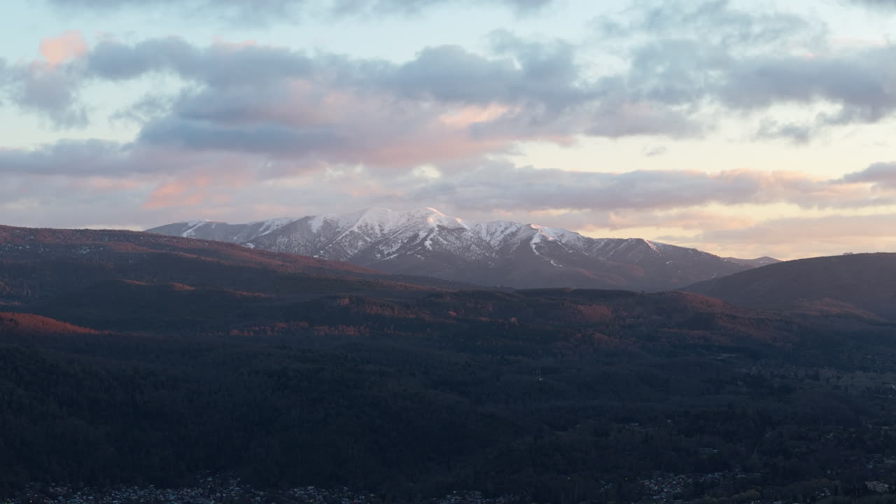 Majestic winter mountain landscape with pine forest at sunset clouds in Patagonia. Cerro Chapelco.