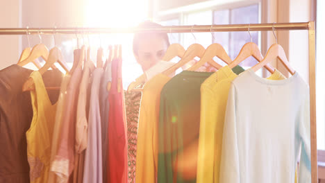 Woman-selecting-clothes-from-clothing-rack