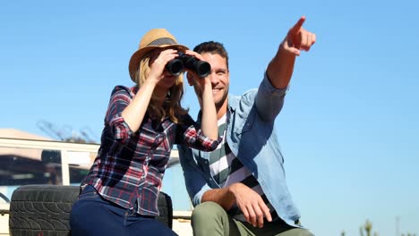 couple looking through binocular 4k