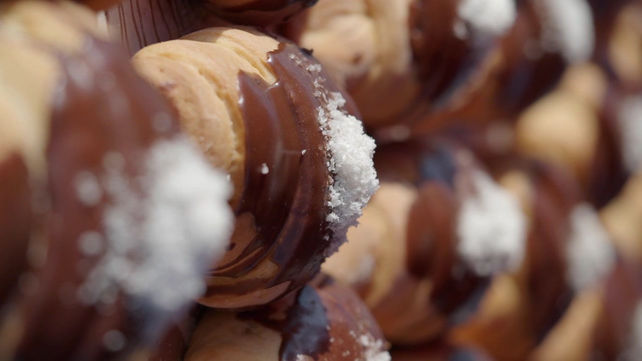 Close-Up of Delicious Chocolate Glazed Pastries with Coconut Sprinkles