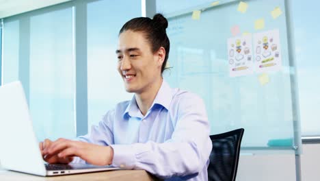 business executive working over laptop at his desk