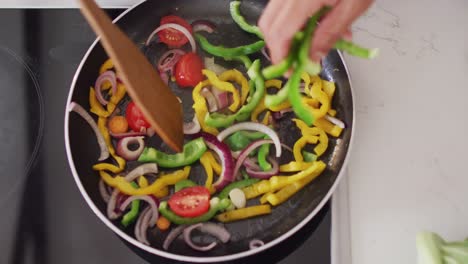 Close up of african american couple cooking with pan in kitchen