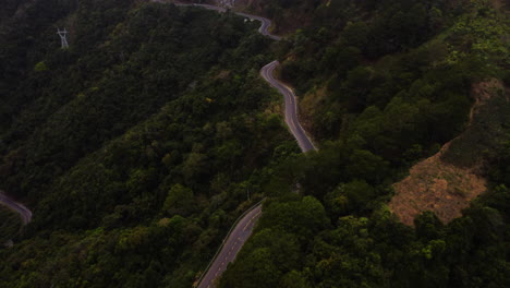 Scenic-curvy-road-through-tropical-forest-in-highlands-by-Da-Lat,-Vietnam