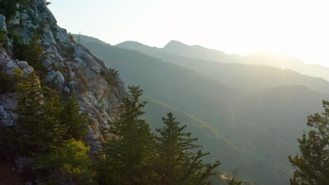 Marvelous-mountain-range-view-at-sunset-with-cliff-in-foreground